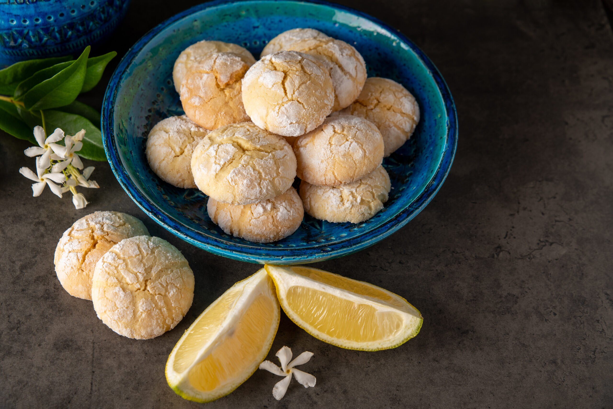 lemon-cookies-and-slices-of-lemon-on-a-dark-table-with-small-whi-2